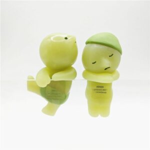 Cute green sleeping figurines with expressions, ideal for decoration and collection, adding charm to spaces.