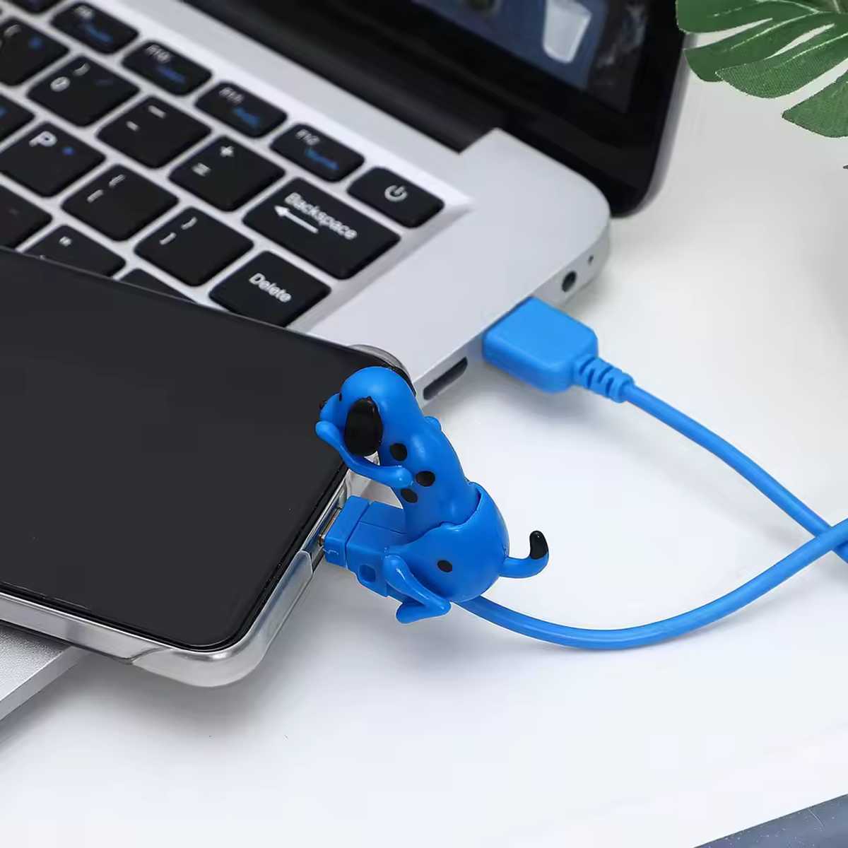 Funny Humping Dog Motion USB Charger – Lightning & Type-C Cable 3 Blue dog-shaped USB cable protector for smartphone charging, connected to laptop. Prevents cable damage.