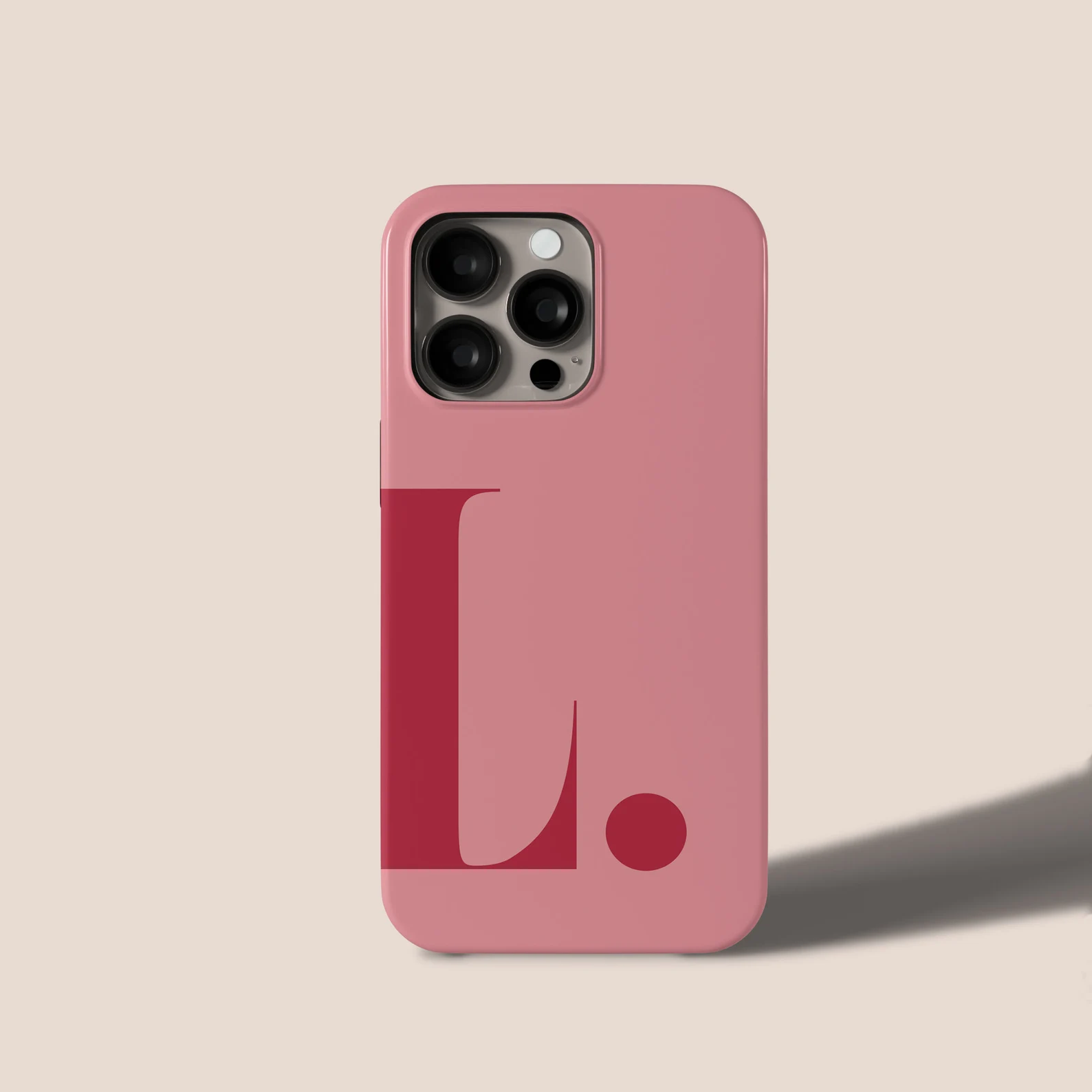 Pink iPhone case with bold red L design, sleek protection and style for modern smartphones.